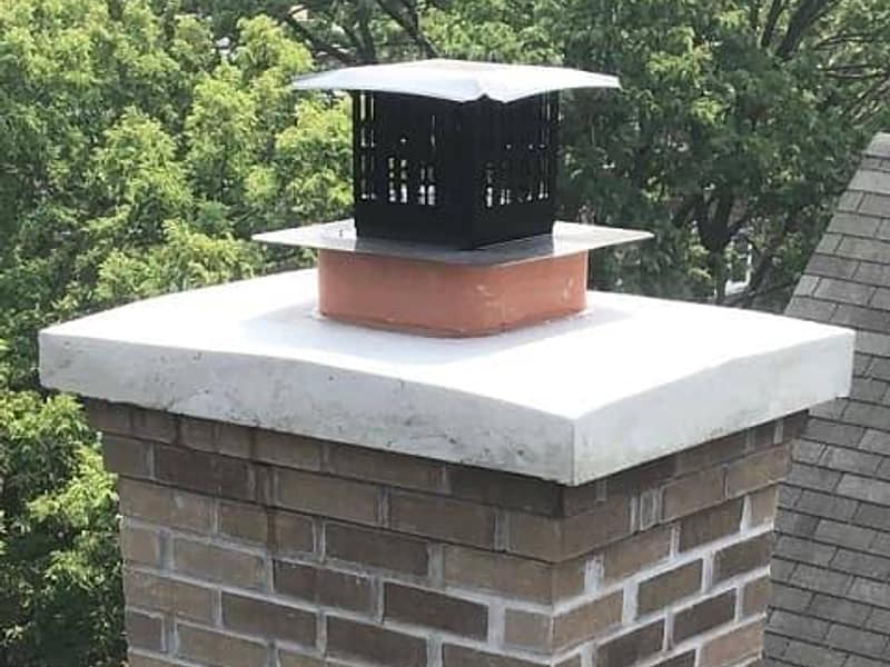 new white crown poured over the brick stack on a chimney in Toms River, NJ