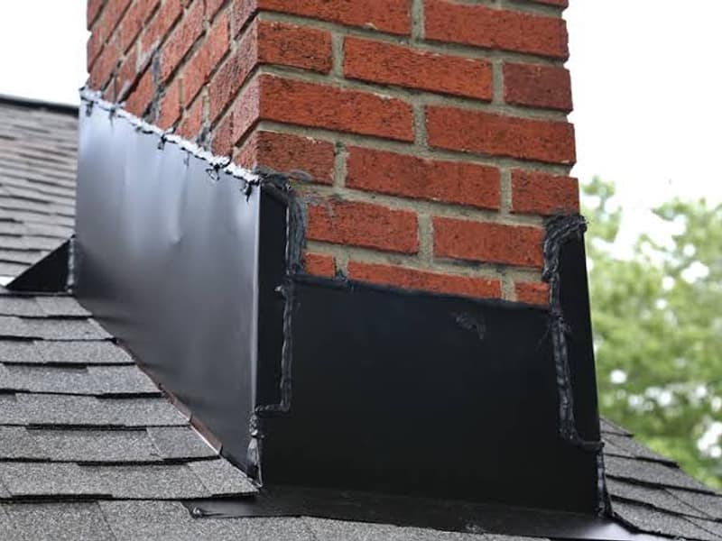 new metal flashing sealed at the roofline on a chimney in Toms River, NJ
