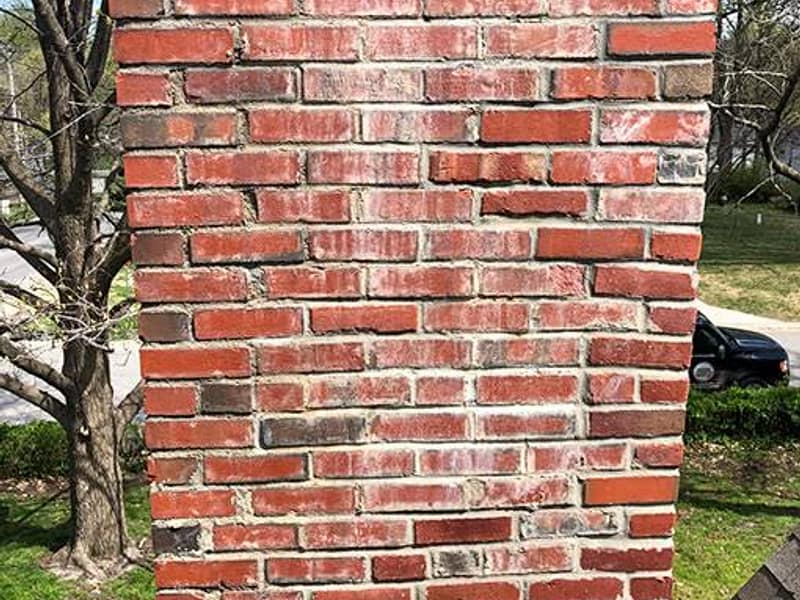 weathered brick face with open mortar joints on a chimney in Toms River, NJ
