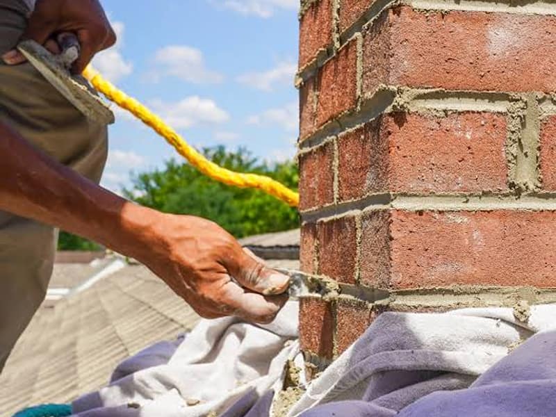 fresh mortar worked into the brick joints on a chimney in Toms River, NJ
