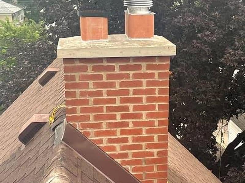 rebuilt brick stack finished with a new crown on a chimney in Toms River, NJ