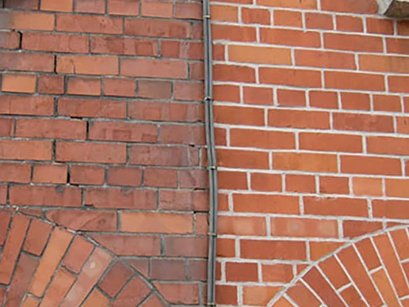 old joints beside freshly repointed brickwork on a chimney in Toms River, NJ
