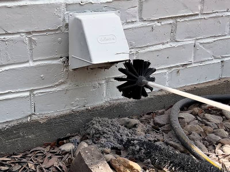 rotary brush entering the dryer vent on a chimney in Toms River, NJ